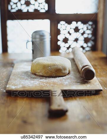Dough, rolling pin on wooden chopping board, making bread View Large Photo Image Stock Photo - Dough, rolling pin on wooden chopping board, making bread. Fotosearch