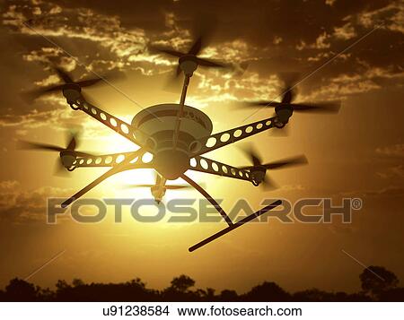 Picture - Drone flying in the sky at sunset. Fotosearch