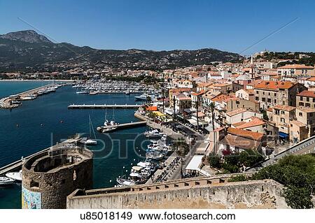 Stock Photo - Elevated view of city walls and waterfront, Calvi, Corsica, France. Fotosearch