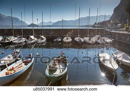 Stock Image - Elevated view of harbour and moored boats, Lake Como, Italy. Fotosearch