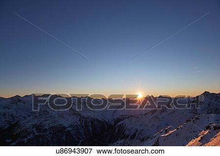 Stock Photo - Elevated view of sunset over snow covered mountains, Gaislachkogel, Soelden, Tyrol, Austria. Fotosearch