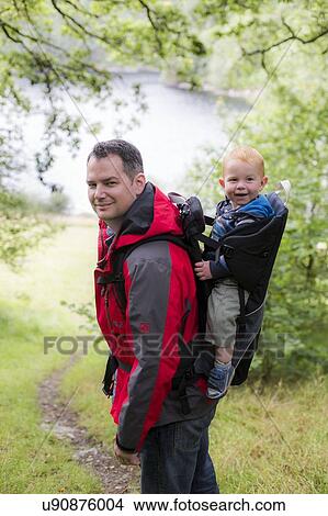 Father carrying son in back carrier View Large Photo Image Picture - Father carrying son in back carrier. Fotosearch