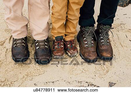 "Father standing with two children, focus on feet" View Large Photo Image Stock Image - "Father standing with two children, focus on feet". Fotosearch