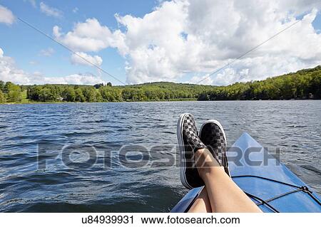 Stock Image - "Feet up on canoe, New Milford, Pennsylvania, US". Fotosearch