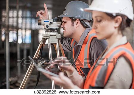 Female and male surveyor using digital tablet and theodolite on construction site View Large Photo Image Stock Photograph - Female and male surveyor using digital tablet and theodolite on construction site. Fotosearch