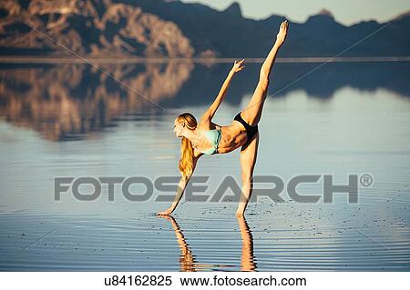 "Female ballet dancer poised in ballet position in lake, Bonneville Salt Flats, Utah, USA" View Large Photo Image Stock Photography - "Female ballet dancer poised in ballet position in lake, Bonneville Salt Flats, Utah, USA". Fotosearch
