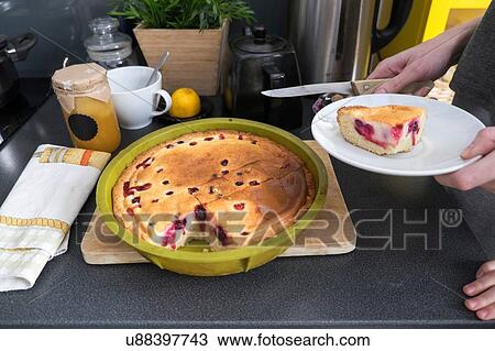 Female hands holding plate with baked cake at kitchen counter View Large Photo Image Stock Image - Female hands holding plate with baked cake at kitchen counter. Fotosearch