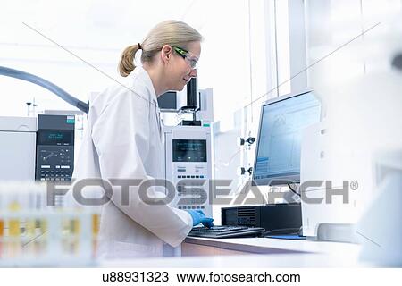 Female scientist at workstation testing oil samples View Large Photo Image Stock Image - Female scientist at workstation testing oil samples. Fotosearch