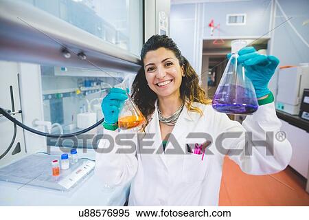 Stock Photography - Female scientist monitoring pH solutions by using ph indicators. Fotosearch