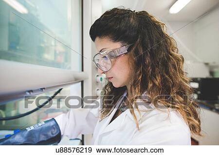 Female scientist preparing chemicals for sol-gel titania synthesis View Large Photo Image Stock Photo - Female scientist preparing chemicals for sol-gel titania synthesis. Fotosearch