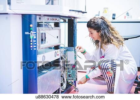 Stock Photo - Female scientist preparing x-ray diffractometer machine. Fotosearch