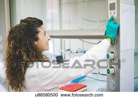 Female scientist switching on chemical hood View Large Photo Image Stock Image - Female scientist switching on chemical hood. Fotosearch