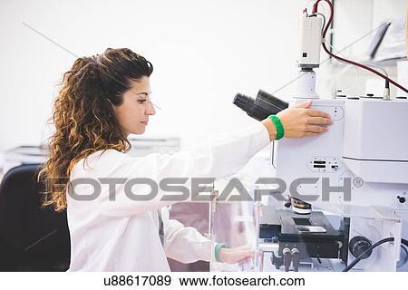 Female scientist using FTIR spectrophotometer, focusing sample on microscope camera, View Large Photo Image Stock Photo - Female scientist using FTIR spectrophotometer, focusing sample on microscope camera,. Fotosearch