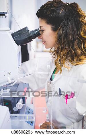 Female scientist using FTIR spectrophotometer, looking at thin film sample through FTIR microscope View Large Photo Image Stock Photography - Female scientist using FTIR spectrophotometer, looking at thin film sample through FTIR microscope. Fotosearch