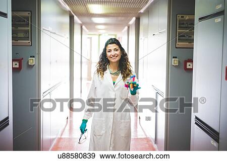 Stock Photo - Female scientist walking in laboratory of material science and nanotechnology. Fotosearch