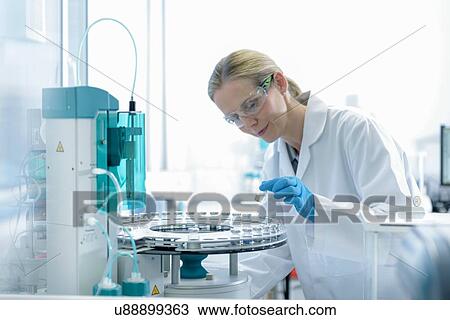 Female scientist with oil sample in testing facility View Large Photo Image Stock Image - Female scientist with oil sample in testing facility. Fotosearch