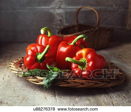 Four red peppers on vintage wicker basket View Large Photo Image Stock Photo - Four red peppers on vintage wicker basket. Fotosearch