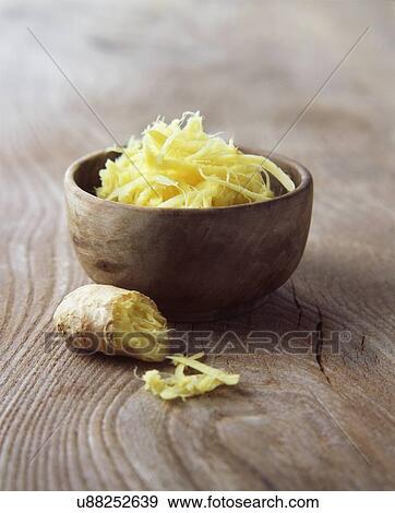 Stock Photo - Fresh ginger root grated in wooden bowl. Fotosearch