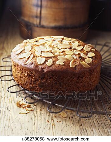 Freshly baked almond fruit cake on vintage cooling rack View Large Photo Image Stock Photo - Freshly baked almond fruit cake on vintage cooling rack. Fotosearch