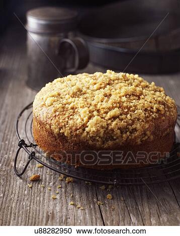 Stock Image - Freshly baked cake on vintage cooling rack. Fotosearch
