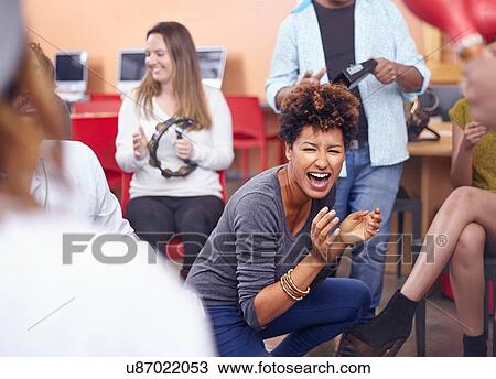 Friends playing musical instruments and dancing, smiling View Large Photo Image Stock Image - Friends playing musical instruments and dancing, smiling. Fotosearch