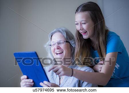 Girl and grandmother using tablet View Large Photo Image Stock Photography - Girl and grandmother using tablet. Fotosearch