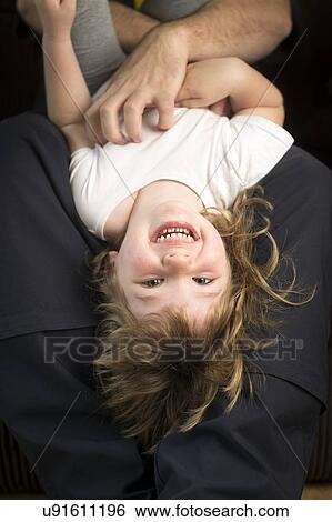 Stock Photograph - "Girl being tickled, laughing". Fotosearch