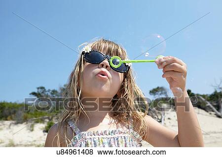 Girl blowing soap bubbles View Large Photo Image Stock Photo - Girl blowing soap bubbles. Fotosearch