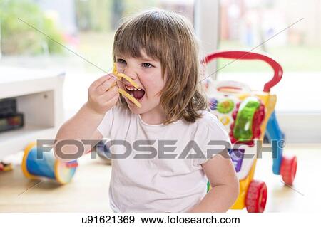 Girl eating french fries View Large Photo Image Stock Photo - Girl eating french fries. Fotosearch