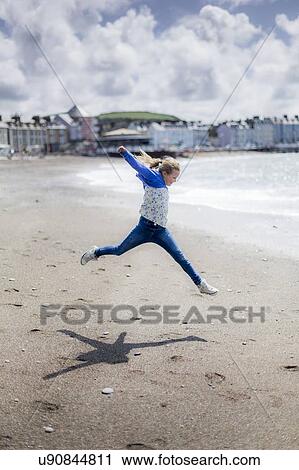 Girl leaping on beach View Large Photo Image Stock Image - Girl leaping on beach. Fotosearch