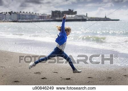 Girl leaping on beach View Large Photo Image Stock Photo - Girl leaping on beach. Fotosearch