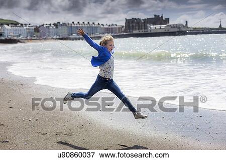 Girl leaping on beach View Large Photo Image Stock Photo - Girl leaping on beach. Fotosearch