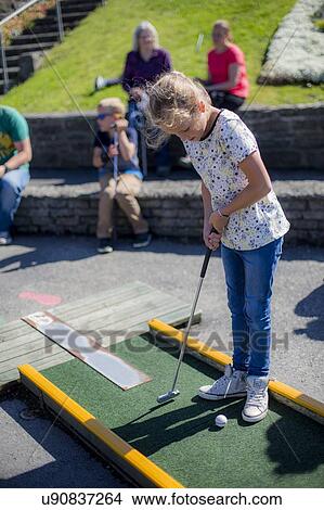 Girl playing mini golf View Large Photo Image Picture - Girl playing mini golf. Fotosearch