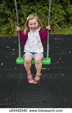 Girl playing on a swing View Large Photo Image Stock Image - Girl playing on a swing. Fotosearch