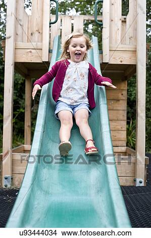 Girl Sliding Down A Slide Picture U93444034 Fotosearch