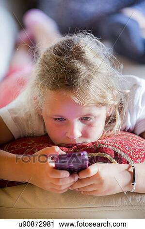 Girl using a smartphone View Large Photo Image Stock Image - Girl using a smartphone. Fotosearch