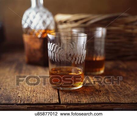 Stock Image - Glasses of whisky on table. Fotosearch