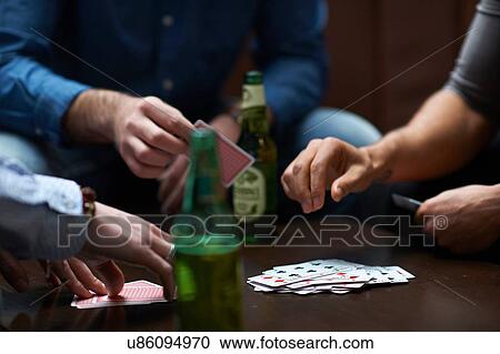 Hands of three men playing card game in traditional UK pub View Large Photo Image Stock Image - Hands of three men playing card game in traditional UK pub. Fotosearch