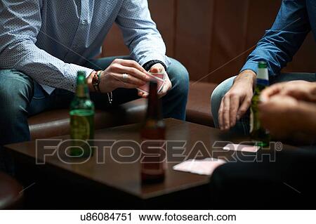 Hands of three men playing cards in traditional UK pub View Large Photo Image Stock Image - Hands of three men playing cards in traditional UK pub. Fotosearch
