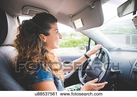 Happy woman driving a car View Large Photo Image Stock Image - Happy woman driving a car. Fotosearch
