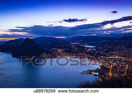 High angle view of Lake Lugano at dusk, Switzerland View Large Photo Image Stock Photo - High angle view of Lake Lugano at dusk, Switzerland. Fotosearch