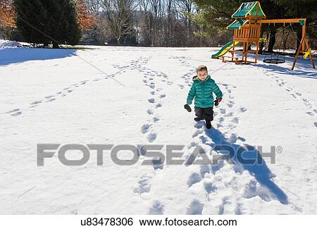 High angle view of preschool boy at playground walking in snow View Large Photo Image Stock Photograph - High angle view of preschool boy at playground walking in snow. Fotosearch
