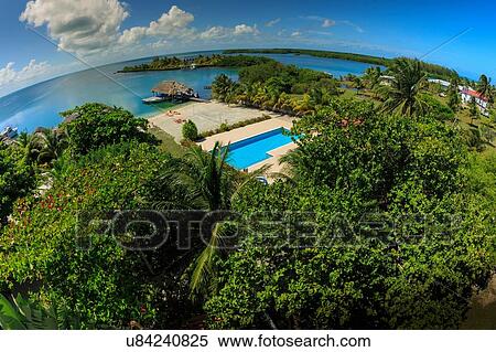 Stock Photography - "High wide angle view of Caribbean sea and coast, St. Georges Caye, Belize, Central America". Fotosearch