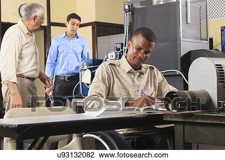 Stock Image - Instructor with student in wheelchair. Fotosearch