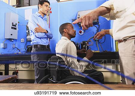 Stock Photo - Instructor with student in wheelchair. Fotosearch