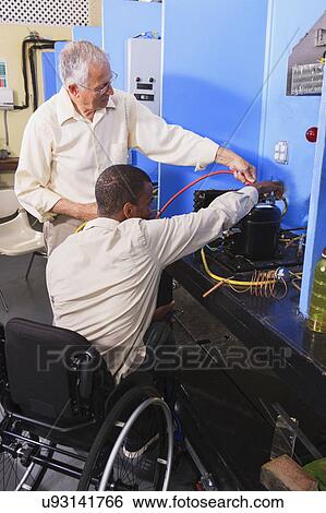 Stock Photograph - Instructor with student in wheelchair. Fotosearch