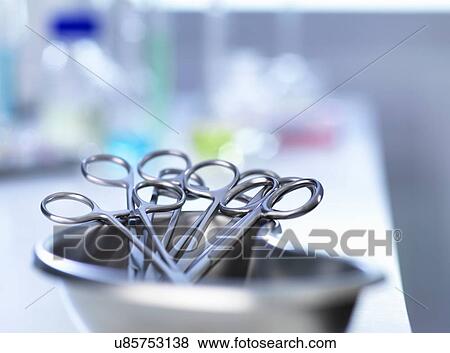 Stock Photo - Kidney-shaped tray with surgical scissors. Fotosearch