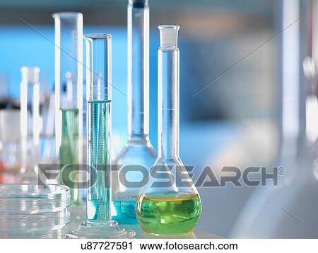 Stock Image - Laboratory glassware on lab bench during experiment. Fotosearch