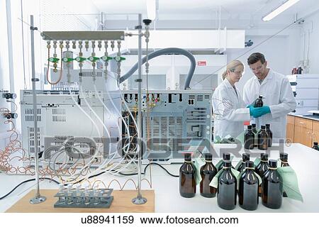 Stock Photo - Laboratory workers testing oil samples. Fotosearch