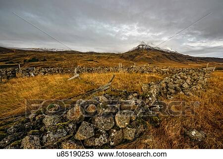 Stock Image - Landscape view of dry stone walls and mount Esja, Reykjavik, Iceland. Fotosearch